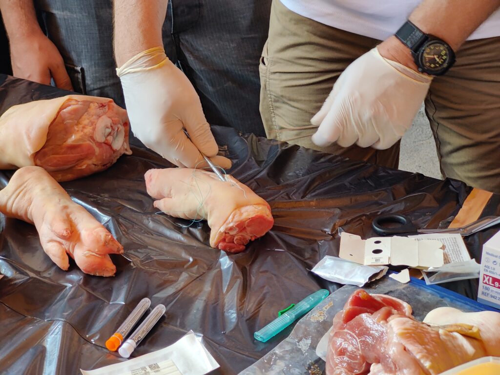 Trainer showing how to stitch up a wound